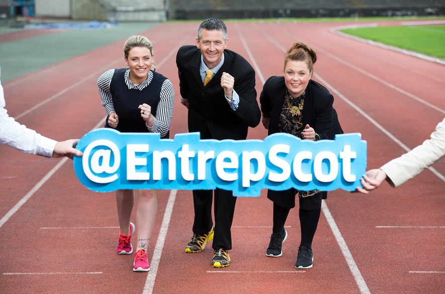 two women and on man in Business attire on running track with logo @entrepScot