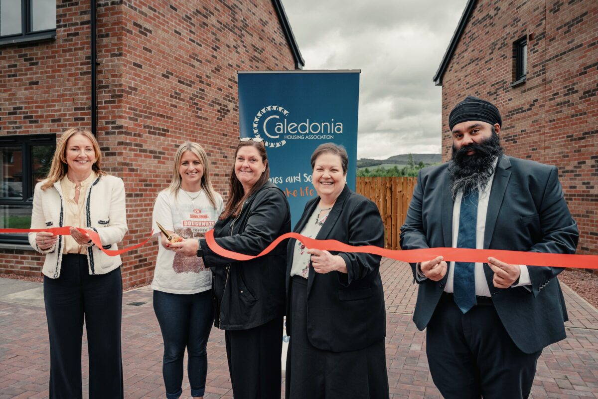 Tenants cutting ribbon to celebrate moving into new homes in Renton.